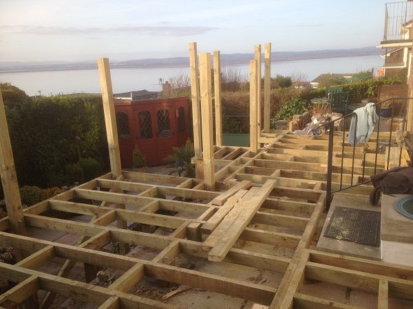 A raised deck frame going in, with the Severn estuary behind