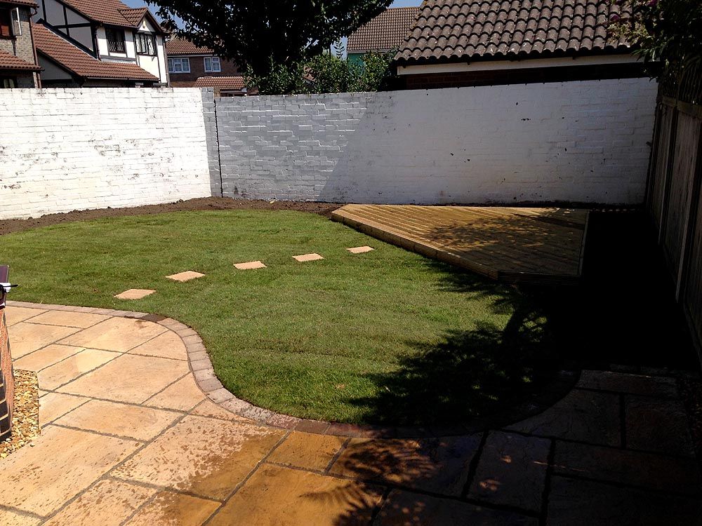 Nailsea after: new sandstone patio with a curved edge and lawn